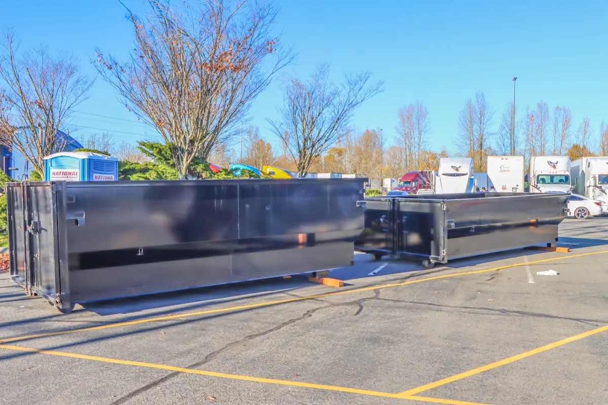 Professional dumpster rental service with roll-off container on residential driveway in Siler City